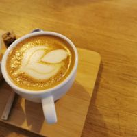 Delicious flat white with a little but very tasty piece of cake at Plenty in The Hague