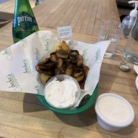 Pan fried vegan potato pierogis topped with sautéed mushrooms and a side of vegan horseradish dip. The meal of my dreams!  at Baba's Pierogies in Brooklyn