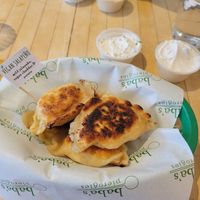 Vegan jalapeno pierogies with vegan sour cream and sour cream and chive dip at Baba's Pierogies in Brooklyn