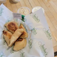Vegan sauerkraut pierogies with vegan onion dip and sour cream at Baba's Pierogies in Brooklyn