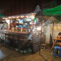 Seating options available under the green canopy on the side. at Thai Food Bar in Pai