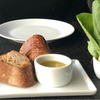 (Left to right) Korean fried broccoli, bread with a plant oil, and greens with a bean dip at the bottom at Dirt Candy in New York City