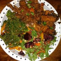 plate with jamaican jerk, kale salad, arugula beet salad and spicy basil tofu at Good Karma Artisan Ales & Cafe in San Jose