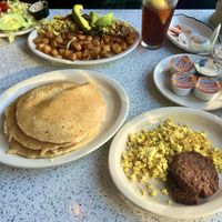 Large stack of pancakes with a side of sausage and very eggy tofu scramble  at The Lindenhurst Diner in Lindenhurst
