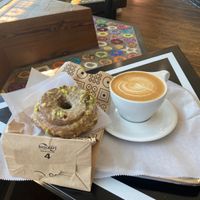 Pistachio vegan sourdough donut and vegan cappuccino.  at Doughnut Plant - Flatbush in Brooklyn