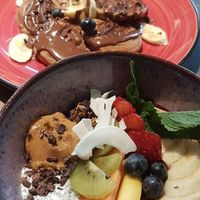 Super Bowl with acai, granola, fruit, peanut butter, chia seeds, cacao nibs. Banana and chocolate spelt pancakes. at Eqvilibrivm Cafe in Barcelona