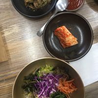 Seasoned taro root, gochujang, vegan kimchi and bibimbap in traditional tableware  at Babiboyak in Jeju