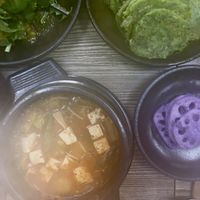  Clockwise: salad, chive pancakes, lotus root and doenjangjigae   at Babiboyak in Jeju