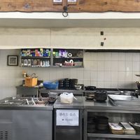 Kitchen and menu on top (only 2 items: bibimbap and tofu stew)  at Babiboyak in Jeju