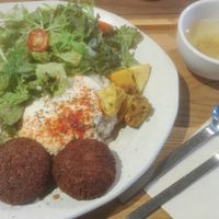 Bowl with rice, salad, tofu hamburger, soy mayonnaise at Mumokuteki Vegan Cafe in Kyoto