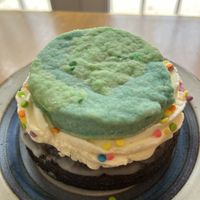 Earth Days donut for #PlantedForThePlanet, chocolate cake donut, vegan buttercream cloud, vegan butter cookie and rainbow confetti. plantedfortheplanet.org  at Lovebirds Donuts in Kittery