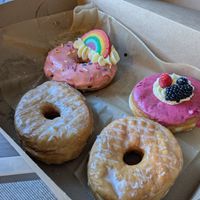 2 glazed brioche donuts, 1 strawberry sprinkle for gay pride, and 1 berry donut at Lovebirds Donuts in Kittery