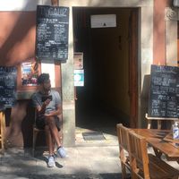 outdoor seating in front of Tragaluz, with menus in the background at Tragaluz in Guanajuato