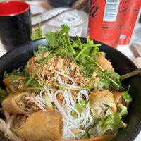 Noodle & veg bowl with mini spring roll pieces. Also available with shredded tofu    at Bun in Paris