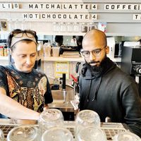 Tanya and Bear showing off Barista skills. at Animal Liberation Kitchen in Toronto