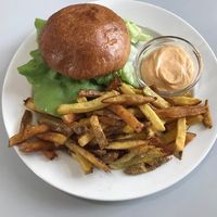 Burger with fries and sriracha mayo at Eaternia in Prague