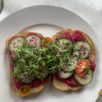 Humdinger sandwich with red beet hummus, cucumber, heirloom cherry tomato, chia and sesame seeds, microgreens at Cafe Otis in Norwich