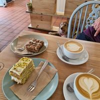 Cinnamon cake, pistachio and lime cake + flat white with oat at The Courtyard in Looe
