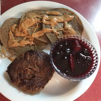 Housemade Beyond breakfast sausage patty, banana oat cakes with peanut butter and house made mixed berry syrup.  at The Red Bird Cafe in Roslyn