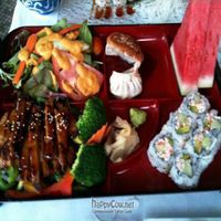 Bento Box: Teriyaki Soy Chicken option. Comes with miso soup, salad, gyoza, california rolls, and fruit. $12. at Soy and Sake Village in New York City