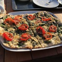 Flammkuchen with spinach, tomatoes and vegan cheese at Primesurf Fehmarn in Fehmarn