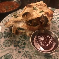 Vegan sausage sandwich with a side of beans  at Dishoom - King's Cross in London