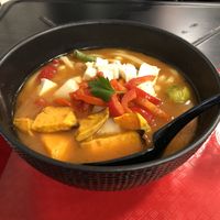 Forbidden Spicy miso broth with udon, veggies, chickpeas, plus my added on tofu and yams.  So good! at REDWHITE BONELESS RAMEN - Boston in Boston