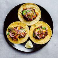 Tacos with refried beans, avocado, chimol, red onions in lime juice and salsa verde. at Tacopop in Copenhagen