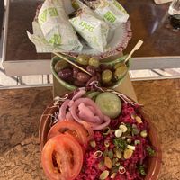 First part of the tapas board. On it are wraps with falafel, olives and a beetroot bulgur salad. at Bistro Calypso in Eindhoven