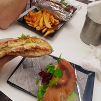 Vegan chicken ciabatta and vegan doggie with fries in the background at Choco Kebab Cafe in Bugibba