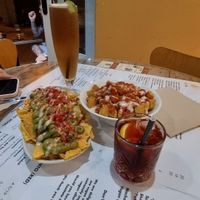 Nachos and patata bravas, long island icetea on the left and negrino on the right. at La Vida in Sliema