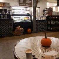Front register with case full of sweets and bakery items at Queen City Grounds in Charlotte