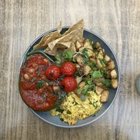 Tofu scrambled eggs, tortilla chips and guacamole, beens and tomato sauce, potatoes   at Jungle Cafe in Galway