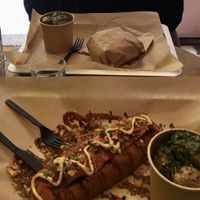 Burger and hot dog with roasted potatoes with chimichurri as a side  at Wholywood in Paris