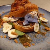 Cinnamon bun with ice cream, banana, biscoff... at Gives a Fork in Geneva