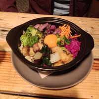 Salad bowl with vegan egg yolk at O Gambuzino in Lisbon