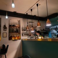 Chefs preparing food in the room at O Gambuzino in Lisbon