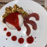 Panna cotta with caramelised pistachios, poached pear and hibiscus gel  at O Gambuzino in Lisbon