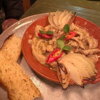 Traditional Portuguese p*rk dish at O Gambuzino in Lisbon