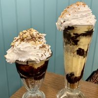 Double choc and nut sundae on the left and lotus sundae on the right   at Cadwaladers in Tenby