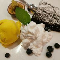 Brownie mit Mango-Eis und veganer Schlagsahne at Schröders at Kurhaus am Inselsee in Guestrow