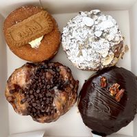Top left: banana pudding. Top right: almond croissant. Bottom left: banana chocolate fritter. Bottom right: caramel turtle    at Machino Donuts - Bloor St in Toronto
