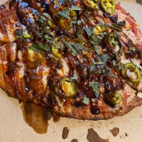 Beyond meat, vegan cheese, jalapeños, Kalamarz olives, basil, bbq drizzle, sriracha, balsamic drizzle  at Oath Pizza in New York City