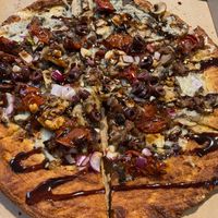 Beyond meatballs, vegan cheese, Kalamarz olives, roasted garlic, roasted cherry tomato, mushrooms, red pepper flakes, balsamic drizzle.  at Oath Pizza in New York City