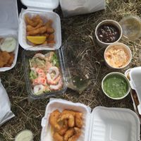 from left: calamari strips, prawn cocktail, scampi, gravy, mushy peas, slaw and some tartar sauce  at Sutton and Sons - Graham Rd in North London