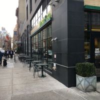 Entrance and outdoor seating.  at fresh&co - 10th Ave in New York City