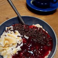 Haferkater's vegan "Waldbeerkater" with German forest berry sauce, roasted coconut flakes and dark chocolate chips. at Haferkater - S-Bf Friedrichstraße in Berlin