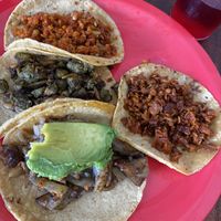 Tacos de carnitas (extra de aguacate), chicharrón y chorizo verde y rojo  at El Bajón Vegano in Tulum