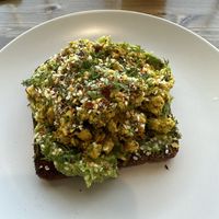 AVOCADO TOAST
AVOCADO. CHILI FLAKES. TOASTED SESAME SEEDS. LEMON. NUTRITIONAL YEAST. SOURDOUGH BREAD. (I had them substitute the fried egg with scrambled tofu)    at Harvest on 25th in Waco
