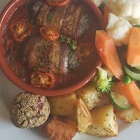 Vegan cream cheese & spinach grilled aubergine rolls in tomato ragout with roast potatoes, steamed veg & stuffing at The Lewiston Loch Ness Inn in Drumnadrochit